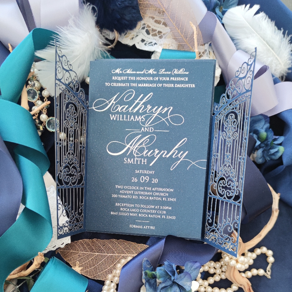 Beautiful Navy paper with gold foil print inside a garden gate styled lasercut invitation.