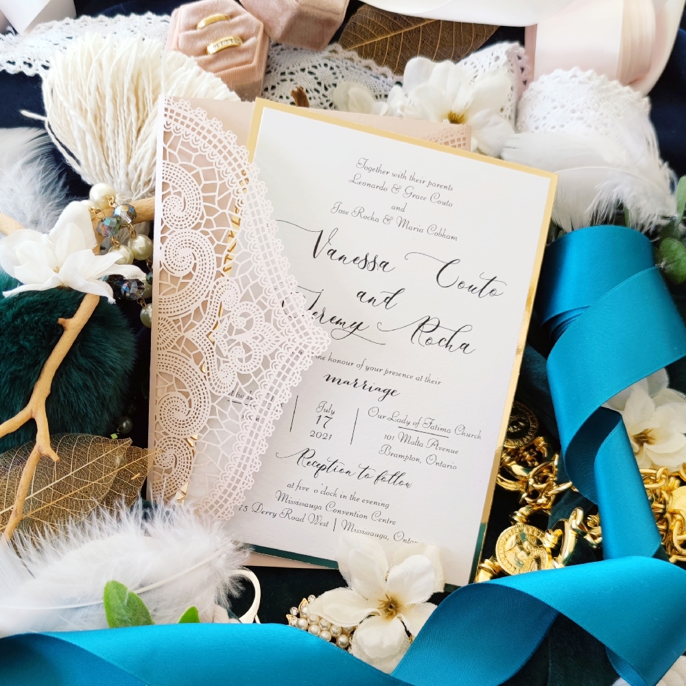 A soft pink lace folder with a layered wedding invite card printed on ice pearl paper.