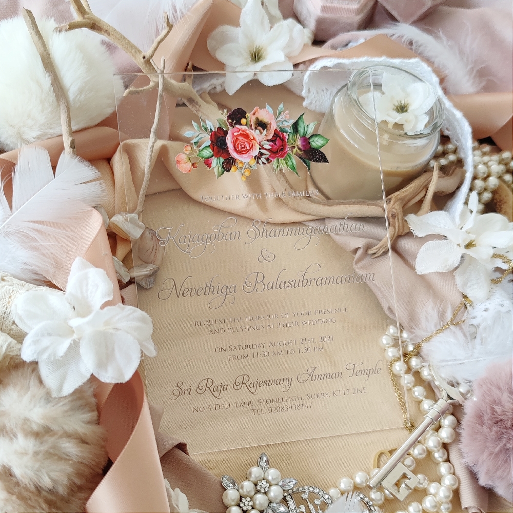 Acrylic clear wedding invite with burgundy and blush floral bouquet at the top of the card.  The ink is a soft gold color.