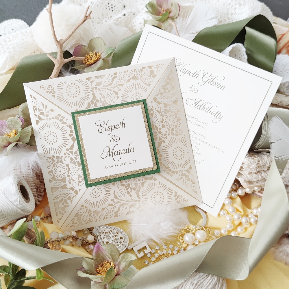 A different type of four flap lace cut wedding invitation.  The tag on the cover is layered with green paper, then champagne glitter paper and the bride & groom\'s names are printed on the top cream paper.