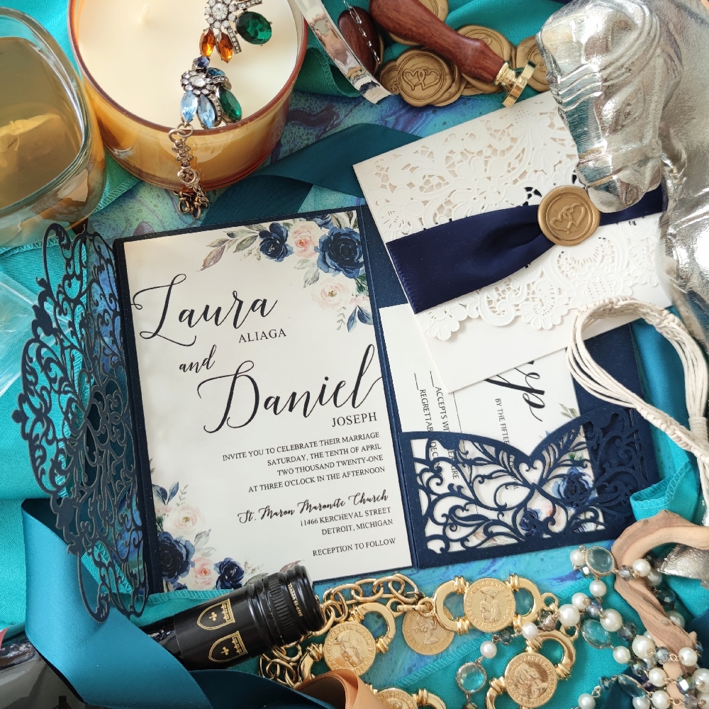 Navy lasercut wedding invitation card that opens into a trifold with a pocket to hold the reply card.