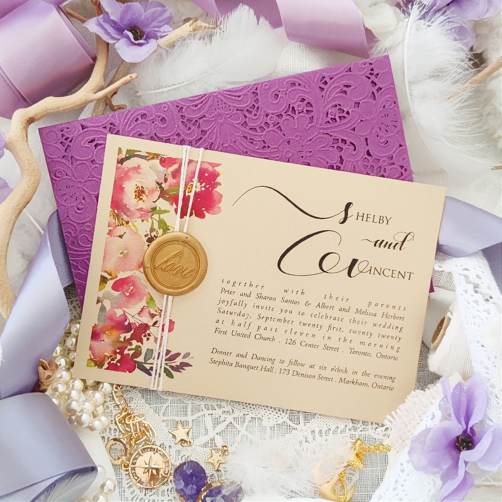 A landscape oriented wedding invitation card with florals and a wax seal on the left and the invitation wording on the right side.