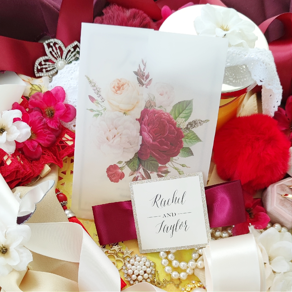 This vellum wrap invitation has the invitation wording printed directly on the vellum wrap.  The burgundy satin ribbon closes the card and the tag has the name of the bride and groom.