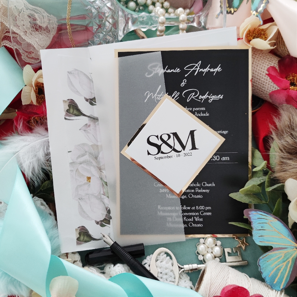 Stephanie & Matthew created an all black wedding invite with a gold mirror backing and cover tag.