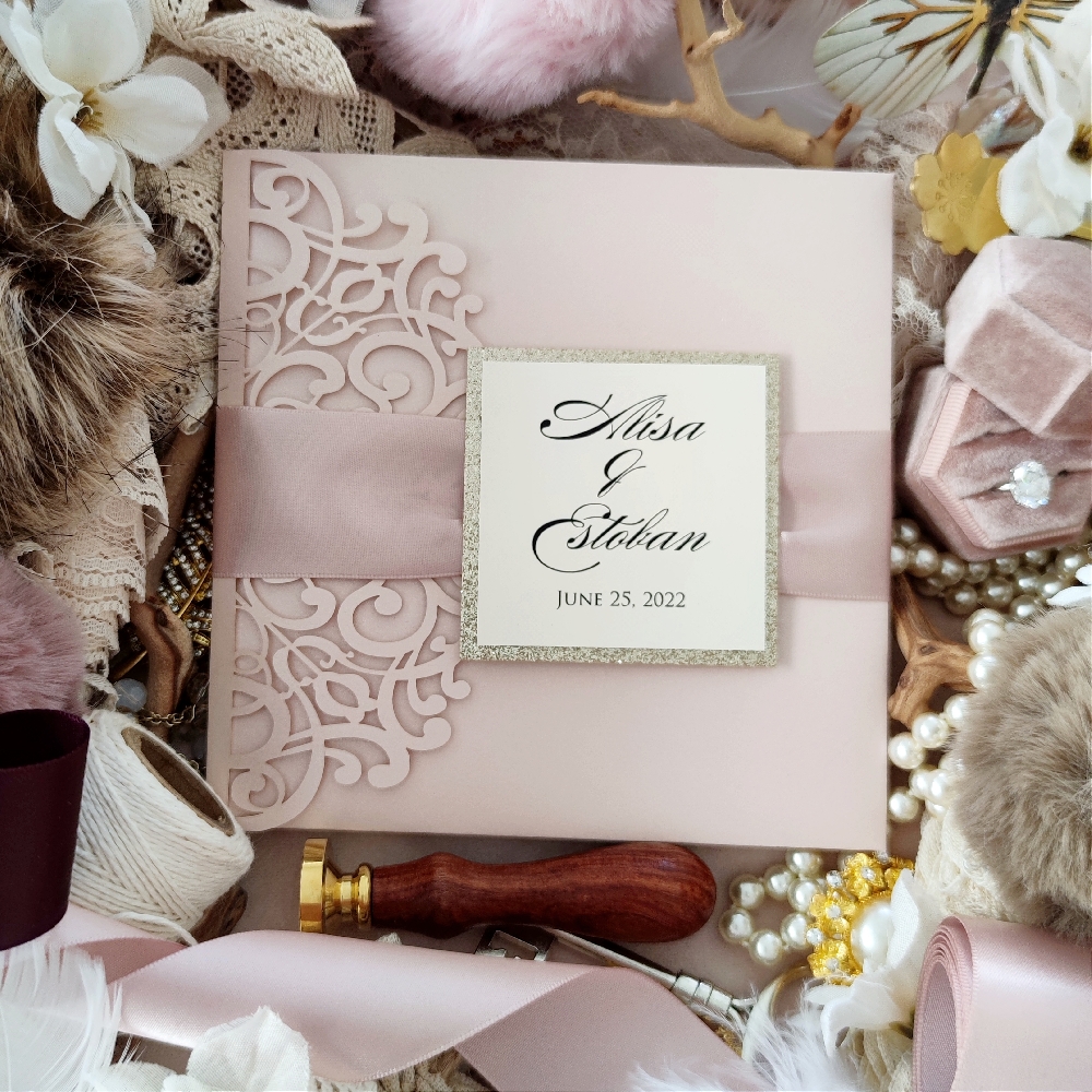 Alisa & Estoban decided on a blush shimmer laser cut wedding invite.  With blush satin ribbon with a champagne glitter tag backing.