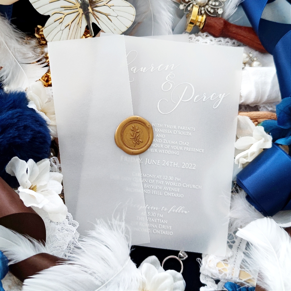 There are 2 wedding invites combined here.  A UV printed Vellum invite and a vellum jacket with gold wax seal.