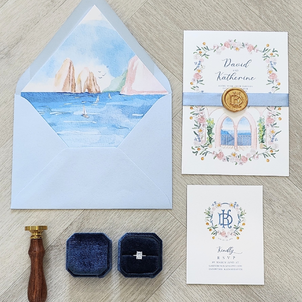 Single card wedding invite on white cotton with blue ribbon and custom gold wax seal.  Blue envelope with a design graphic printed liner.