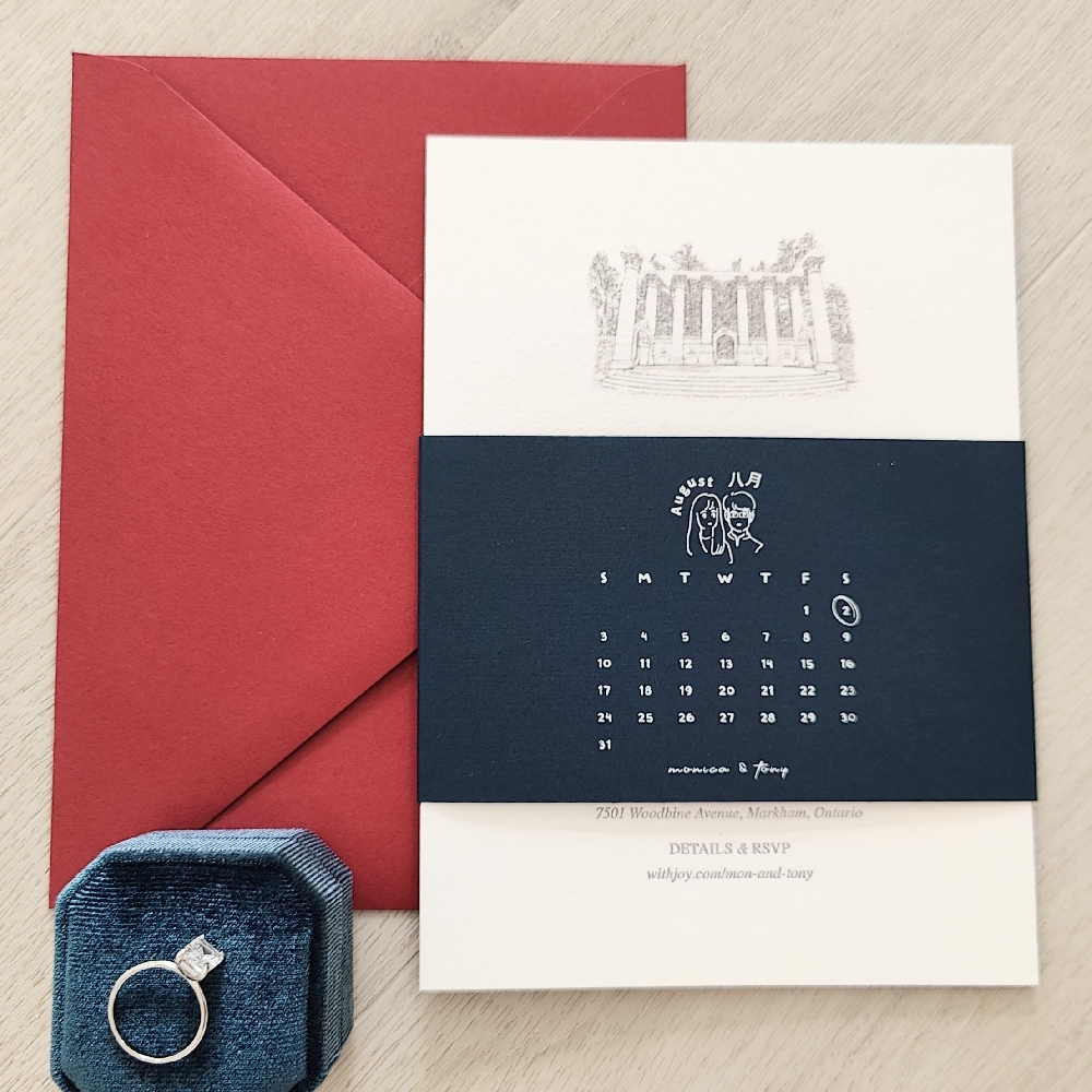 Letterpress wedding invite with a printed design on a black belly band.  Paired with a red lacquer envelope.