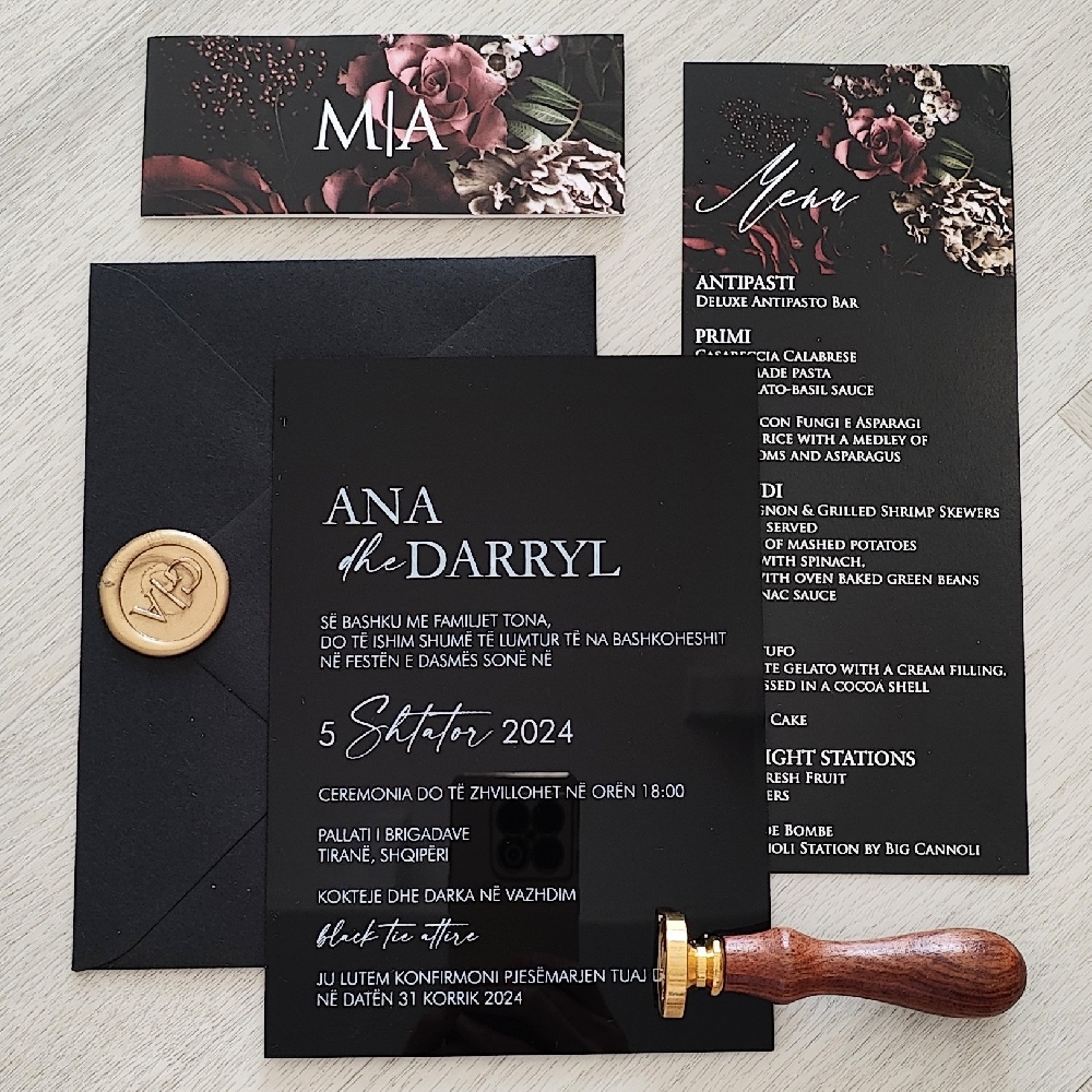 Solid black acrylic wedding card with a printed belly band.  Black envelope with gold wax seal.