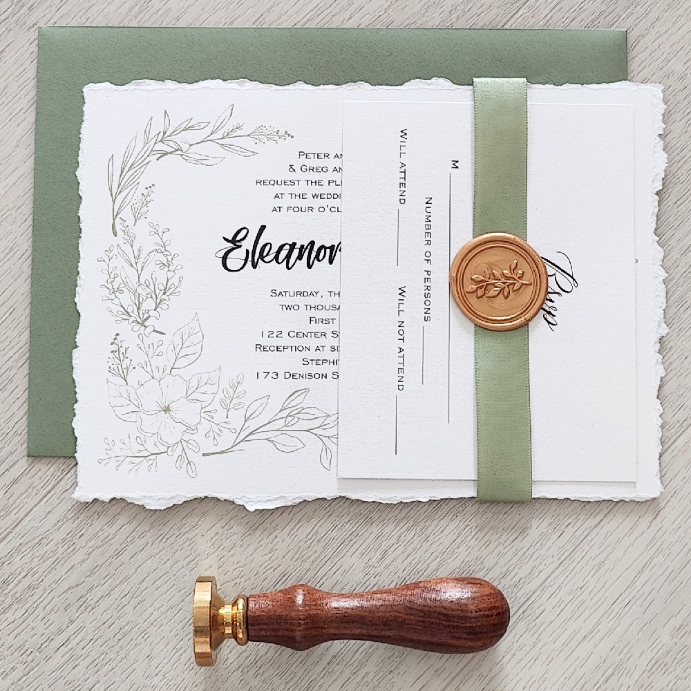 Deckle edge wedding invite with ribbon and wax seal with a green envelope