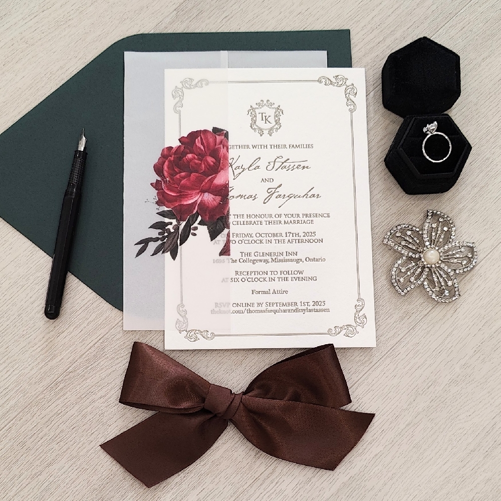 Single card wedding invite with a custom floral printed vellum wrap along with a brown satin bow.  This is paired with a ebony black envelope.