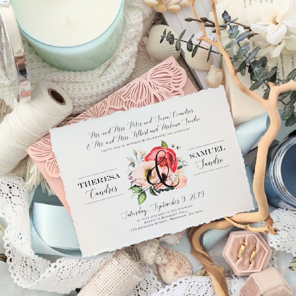A landscape designed wedding invitation with deckled edge and blush and pink florals.