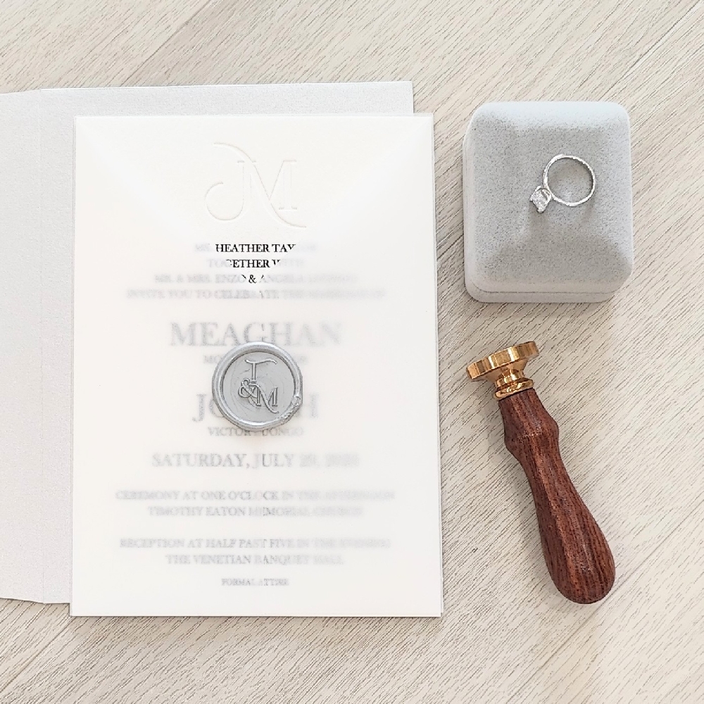 This is a single card wedding invite with a custom cut vellum wrap and silver wax seal embellishment.