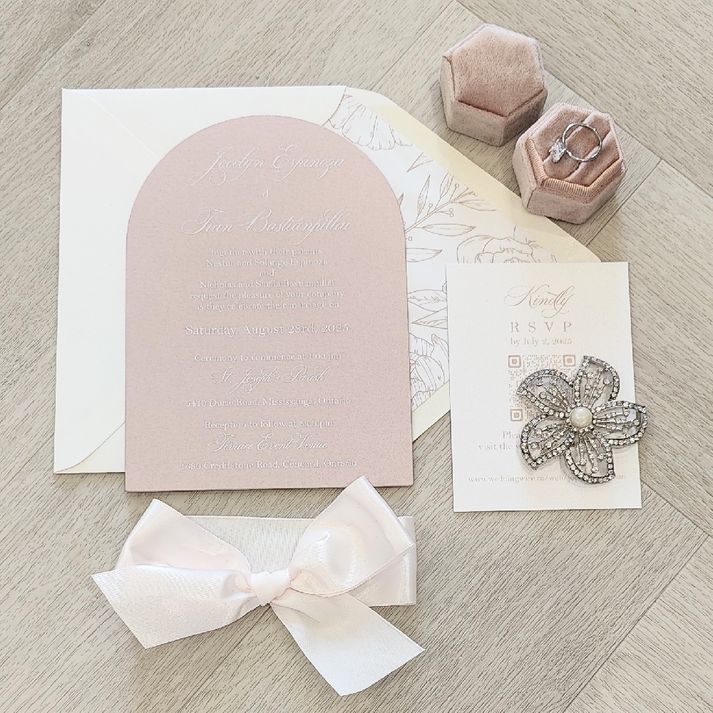 Arch shaped invitation with an antique ivory ribbon bow.  Neutral envelope with a printed floral design liner.