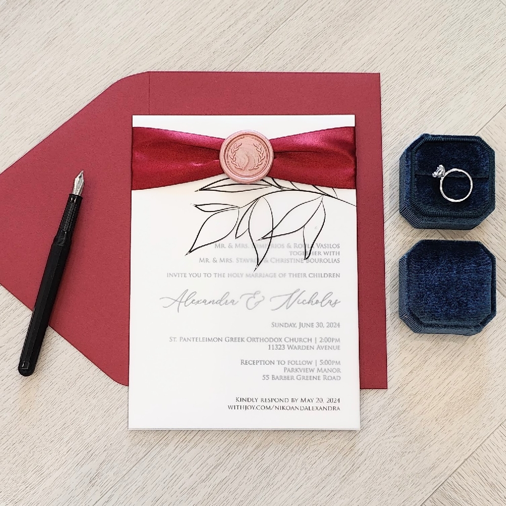 Single card invite with a vellum overlay, ribbon and wax seal embellishment.  It is paired with a red lacquer envelope.
