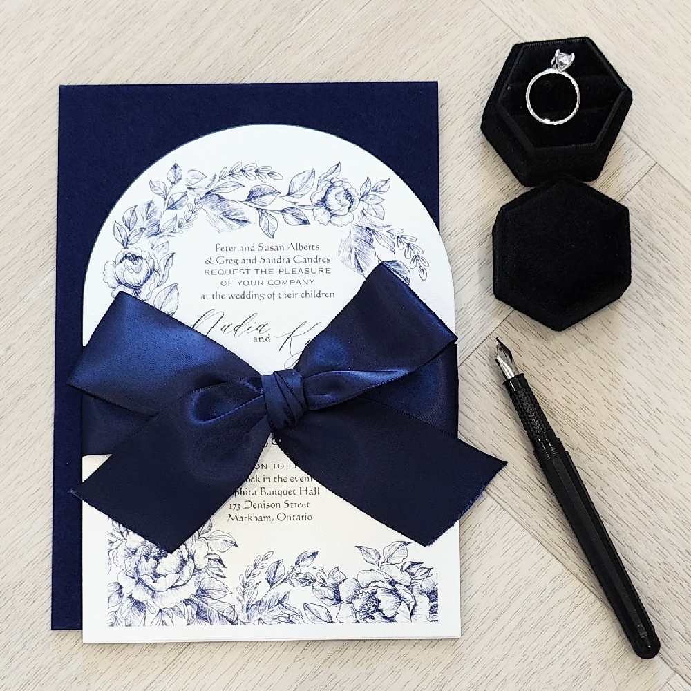 Arched shaped wedding card with a navy bow and navy blue envelope
