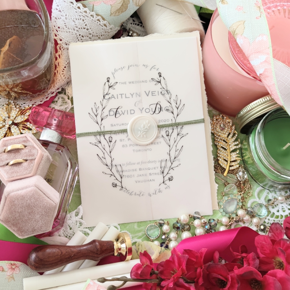 Vellum gate fold invitation with string and wax seal.