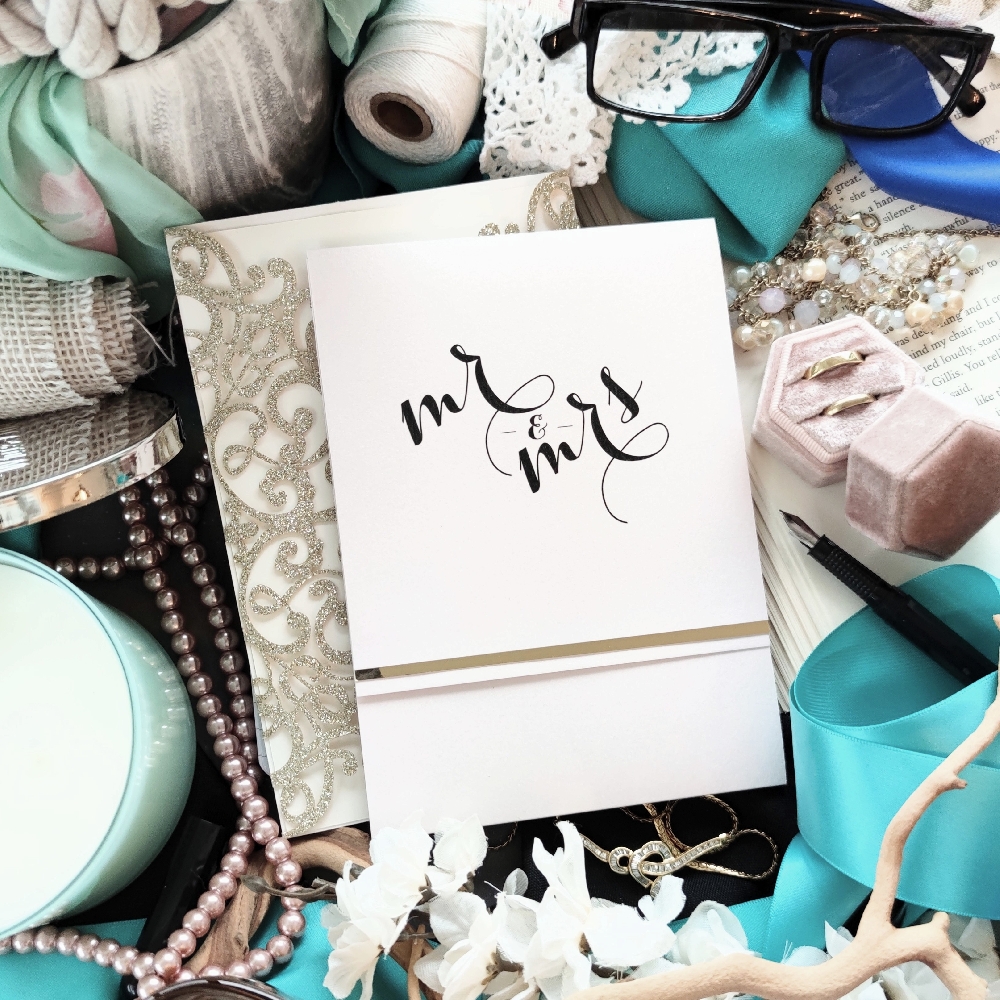 Ice Pearl pocket fold wedding invitation with a trim of gold chrome.