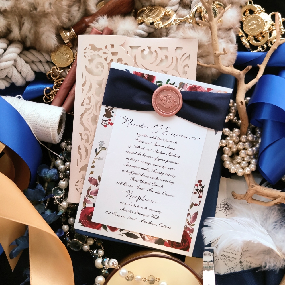 Layered card design with navy ribbon and blush wax seal.