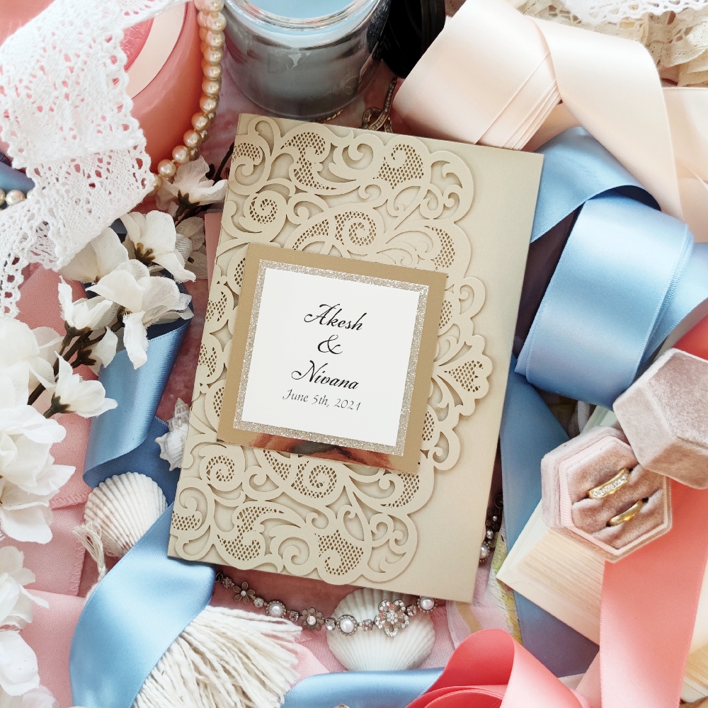 Lasercut pocketfold wedding invitation in the champagne metallic shimmer paper.