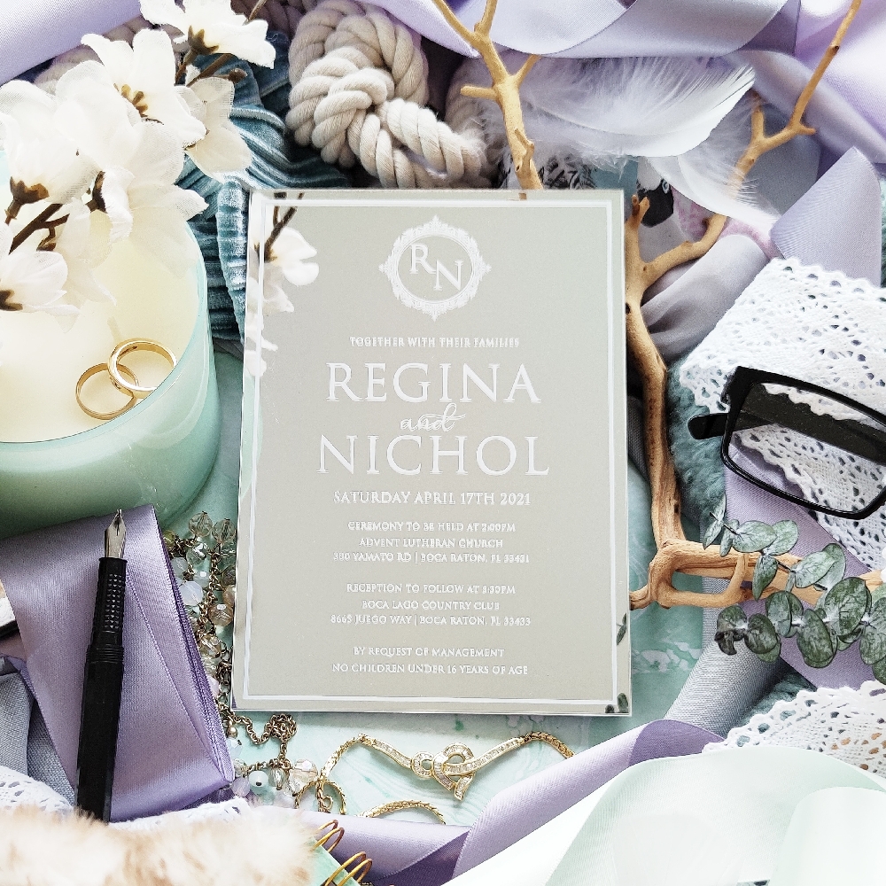 5x7 silver mirror acrylic wedding invitation with monogram at the top.