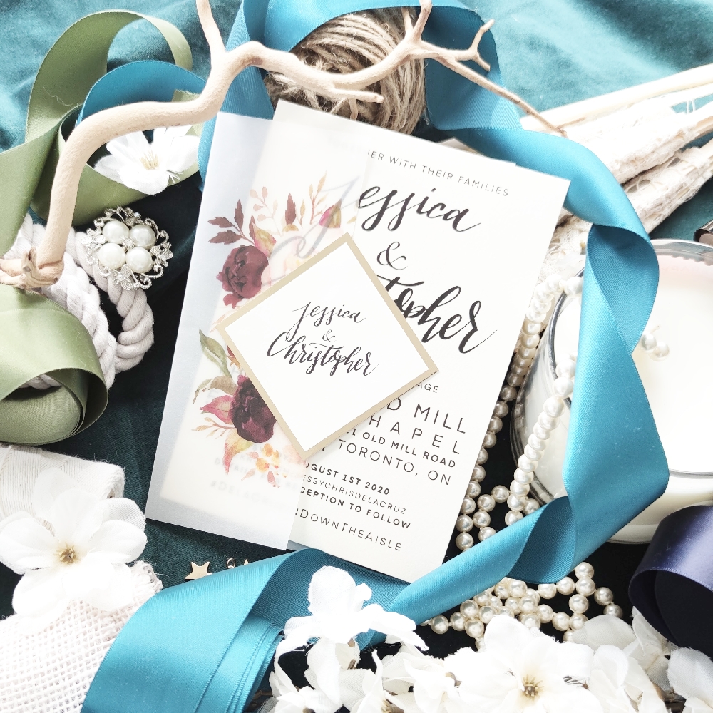 Floral printed vellum wrap around invitation card with diamond cover tag.