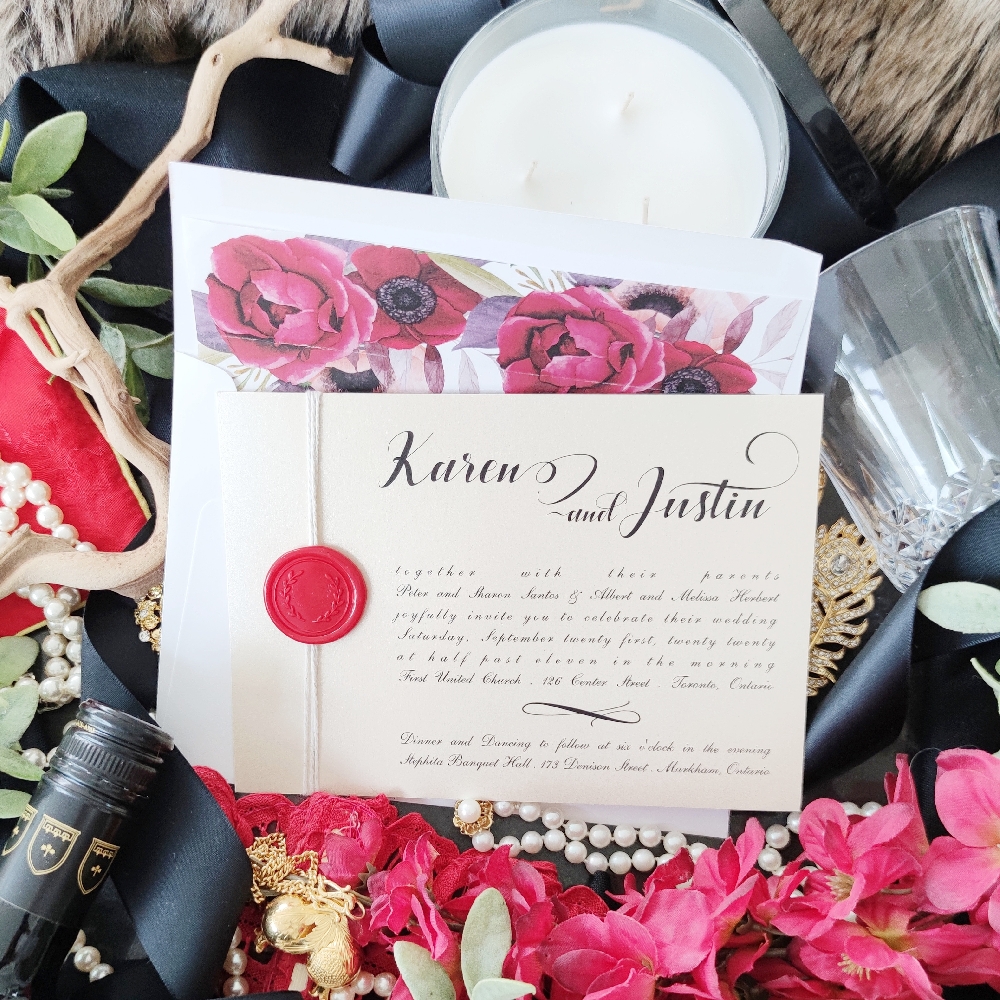 This invitation uses a white string tied vertically around the card and it is finished with a red wax seal.
