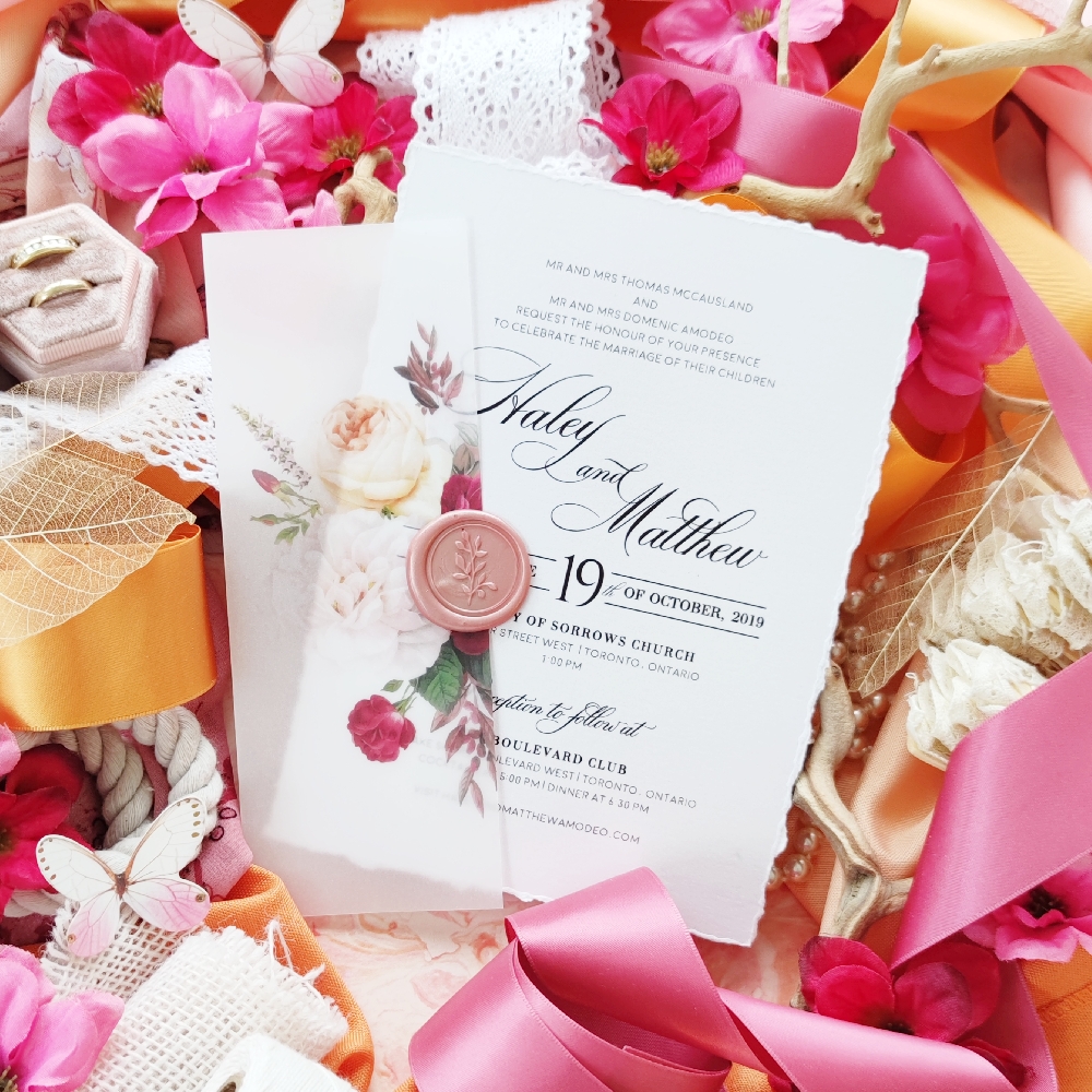 Torn edge invitation card inside a vellum wrap gate fold.