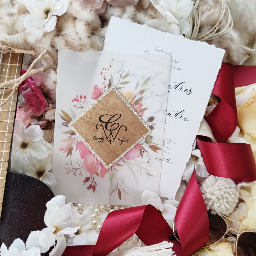 Large bring pink florals printed on vellum wrap with deckled paper for the invitation card.