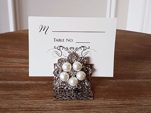 Placecard PC11:  - This is a single card placecard slotted into a brooch stand filigree holder.