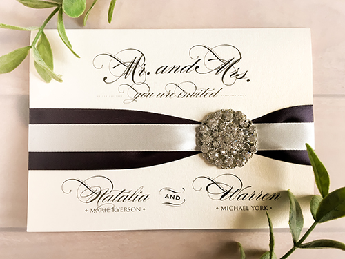 Invitation 1685: White Gold, White Gold, Deep Charcoal Ribbon, Antique Ribbon, Brooch/Buckle X - This is a full flap white gold pearl pocket folder wedding invite.  There is two ribbon stripes and brooch on the cover.