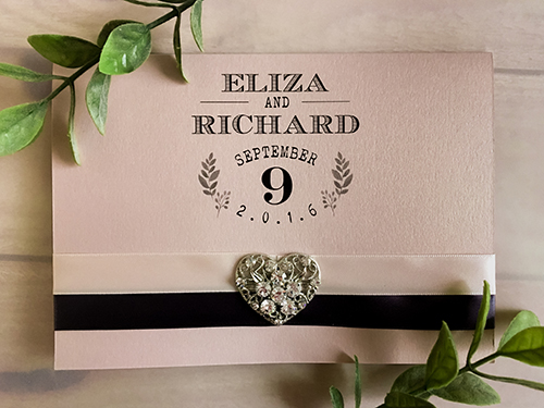 Invitation 1688: Blush Pearl, Blush Pearl, Blush Ribbon, Deep Charcoal Ribbon, Brooch/Buckle U - This is a blush pearl full flap pocketfolder wedding invite with two ribbon stripes and a heart shape brooch.