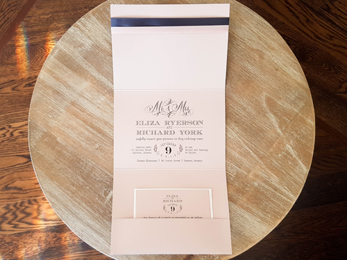 Invitation 1688: Blush Pearl, Blush Pearl, Blush Ribbon, Deep Charcoal Ribbon, Brooch/Buckle U - This is a blush pearl full flap pocketfolder wedding invite with two ribbon stripes and a heart shape brooch.