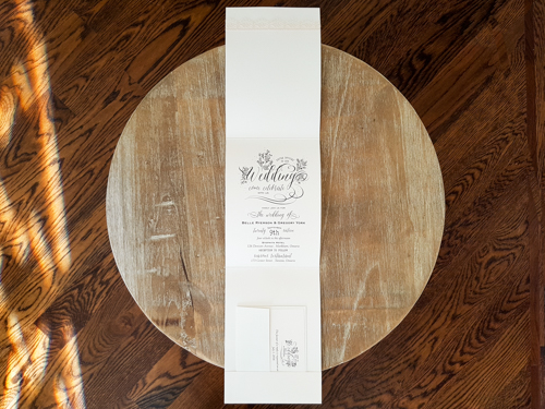 Invitation 1761: Ivory Pearl, Ivory Pearl, Cream - Thin Lace, Brooch/Buckle G - This is a full flap ivory pearl pocket folder wedding invite.  There is a thin lace and brooch detail on the bottom of the flap.