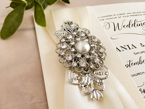 Invitation 2170: White Gold, Antique Ribbon, Antique Ribbon, Brooch/Buckle A6, Metal Filigree F4 - Silver - This is fold over wedding invite in white gold with 2 antique ribbons and combo brooch on the left side.