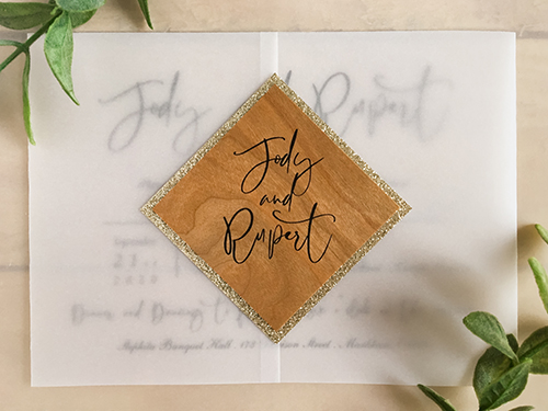 Invitation 2207: This invitation opens left and right like a gate fold and we use a tag placed diagonally on the cover to close the invitation.  It uses our vellum paper as well as our wood paper to create a rustic vibe.