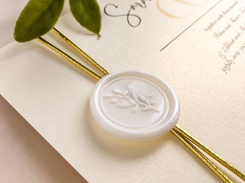 Invitation 2276: White Gold, Ivory Wax - This is a single card printed invite on White Gold pearl.  There is a gold elastic wrapped around twice with an ivory branch wax seal.