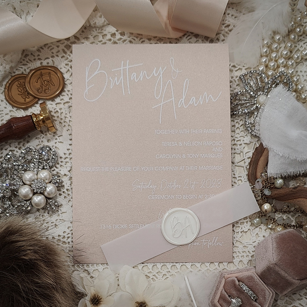 Invitation 3707: Blush Pearl, Ivory Wax - White ink printing on blush pearl paper with a vellum belly band and ivory custom wax seal.