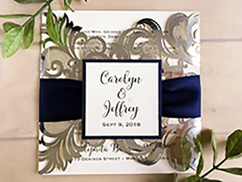 Invitation lc102: Mirror Silver, Cream Smooth, Navy Ribbon - This is a silver mirror damask pattern gate fold laser cut wedding invite.  There is a navy ribbon with a navy pearl layered cover tag.