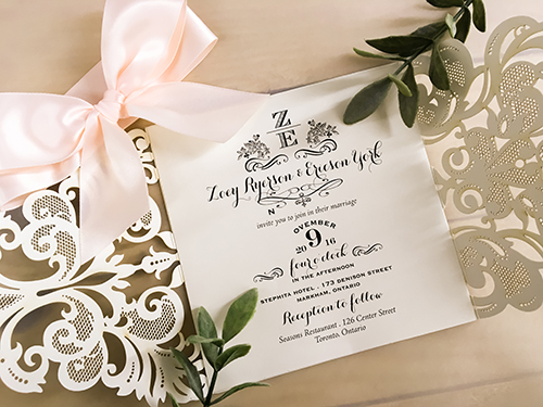 Invitation lc113: Glitter Silver, Cream Smooth, Petal Pink Ribbon - This is a silver glitter finish gate fold laser cut wedding invite.  There is a big petal pink bow tied around.