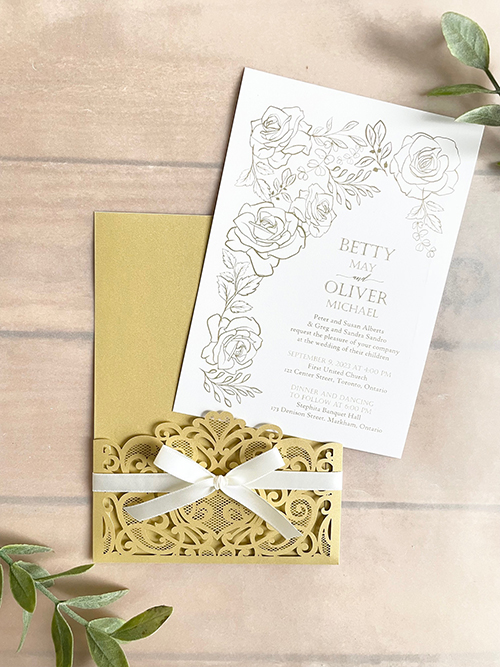 Invitation lc159: Antique Ribbon - Metallic gold colored lasercut wedding invitation with a delicate bow.
