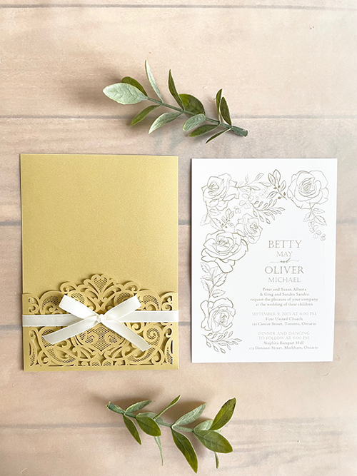 Invitation lc159: Antique Ribbon - Metallic gold colored lasercut wedding invitation with a delicate bow.