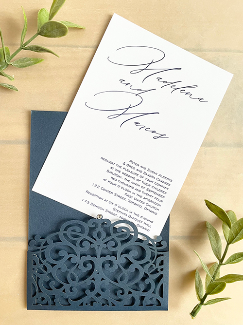 Invitation lc162:  - This is a navy shimmer lasercut wedding invitation with a small rhinestone decorative piece.  The invitation card pulls out of the pocket.