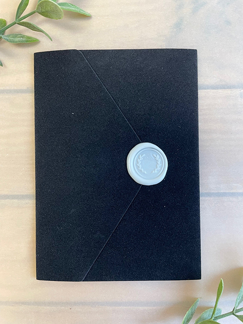 Invitation lc167: Black Velvet, Cream Smooth, Ivory Wax - An elegant black velvet pocket fold wedding invitation with an envelope V flap finished with an ivory wax seal.