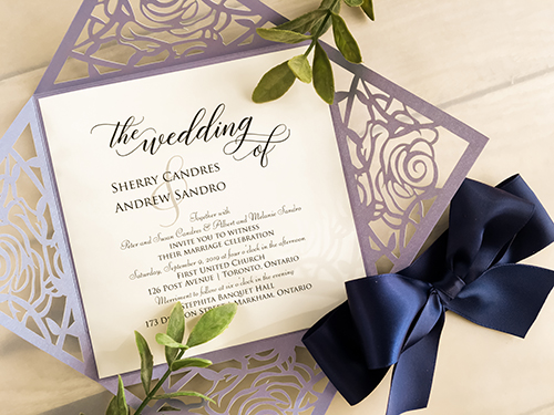 Invitation lc28: Lavender Shimmer, Cream Smooth, Navy Ribbon - This is a lavender shimmer laser cut wedding card.  The pattern is a rose design.  There is a big navy bow tied around.