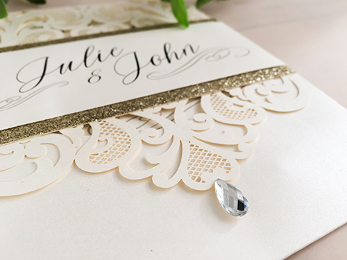 Invitation lc58: Ivory Shimmer, Champagne Glitter, Cream Smooth - This is an ivory shimmer pocket style laser cut wedding invite.  There is a champagne glitter layered belly band.