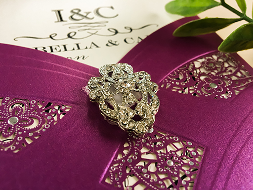 Invitation lc70: Purple Shimmer, Brooch/Buckle A17 - This is a purple shimmer pocket style laser cut wedding invitation.  There is a rhinestone brooch glued to the front.