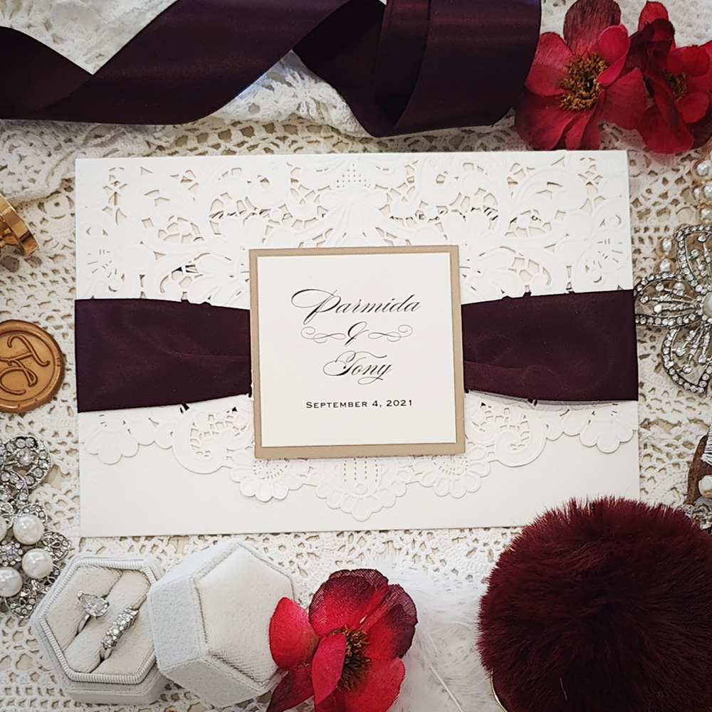 Invitation 8001: Ivory Shimmer, Gold Mirror, Cream Smooth, Eggplant Ribbon - Lasercut bifold with eggplant ribbon and layered tag