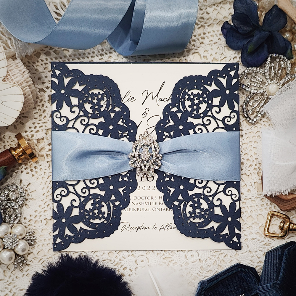Invitation 8005: Glittering Navy, Cream Smooth, Blue Mist Ribbon, Brooch/Buckle A17 - navy lasercut with blue mist ribbon and brooch