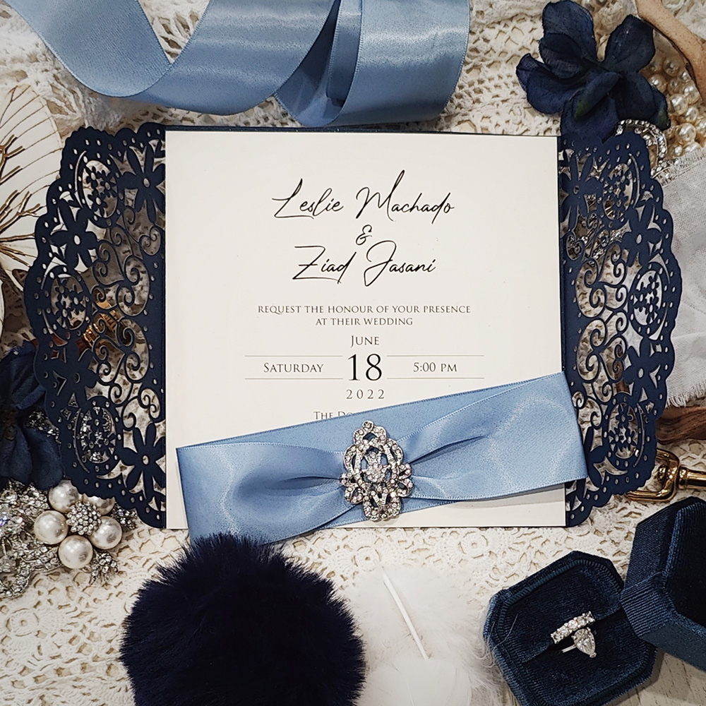 Invitation 8005: Glittering Navy, Cream Smooth, Blue Mist Ribbon, Brooch/Buckle A17 - navy lasercut with blue mist ribbon and brooch